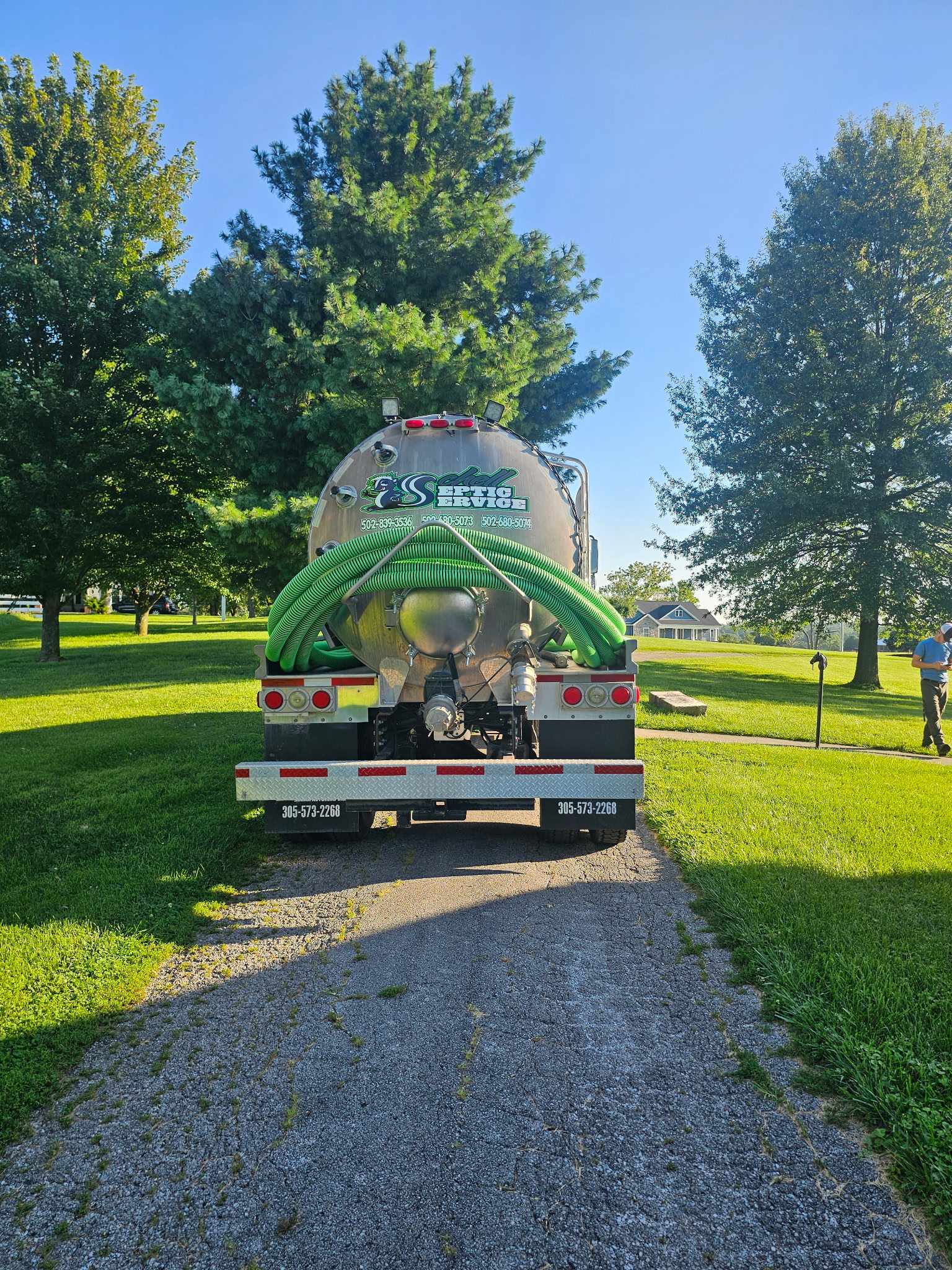 Technicians servicing a septic tank Schell Septic Service technicians servicing a septic tank in Lawrenceburg area